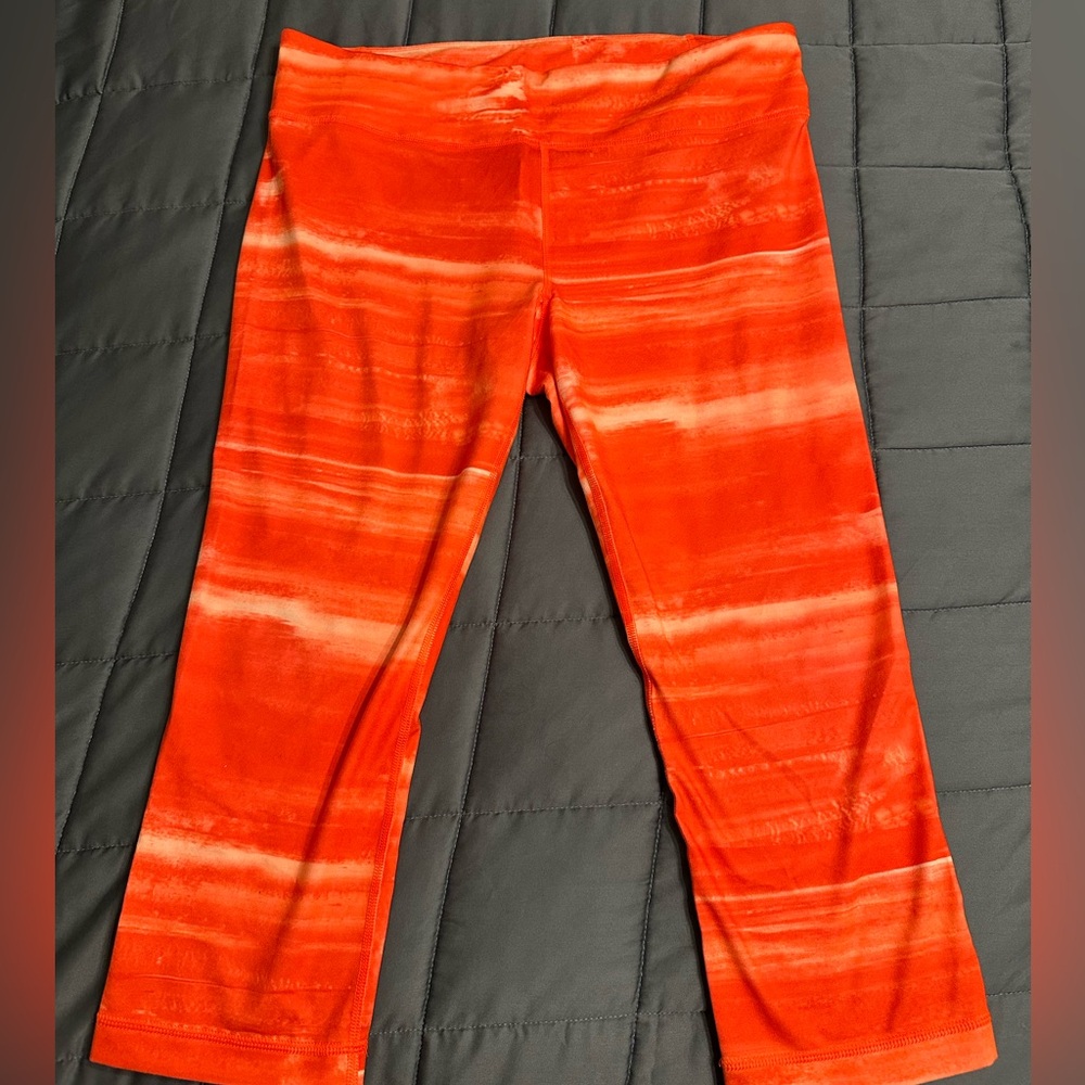 Neon orange tie dye all season gear capris from under armour, size large.